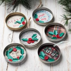 four tins filled with christmas decorations on top of a table