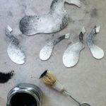 the paint is being used to make silver spoons and other things that are on the floor