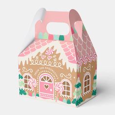 a pink and green box with a gingerbread house on it