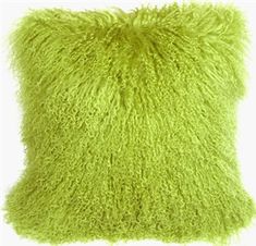 a lime green pillow with fluffy fur on it's sides and the back side