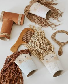 some craft items are laying out on the table together, including hairbrushes and combs