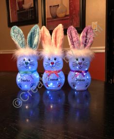 three plastic easter bunnies sitting on top of a table