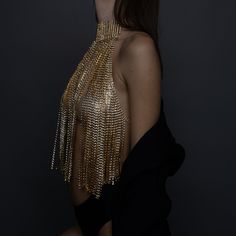 Turn heads and make a statement with our stunning Gold Crystal Chain Halter Top. This exquisite piece of evening wear is designed to dazzle and impress, perfect for special occasions, glamorous nights out, or any event where you want to shine. Premium Quality: Crafted from high-quality materials, this halter top features intricately linked gold chains adorned with sparkling crystals. Unique Design: The backless design with delicate chain details adds a touch of elegance and sophistication, ensur Gold Embellished Evening Necklaces, Glamorous Silver Body Jewelry For Party, Gold Embellished Evening Necklace, Glamorous Silver Body Chain For Party, Glamorous Gold Body Chain For Evening, Glamorous Gold Necklace For Evening, Luxury Embellished Necklaces For Party, Glamorous Embellished Gold Jewelry, Glamorous Gold Embellished Jewelry