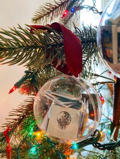 an ornament hanging from the top of a christmas tree