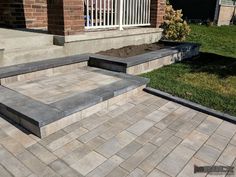 a brick patio with steps leading up to it