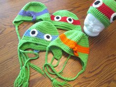 "Crochet Ninja Turtle Beanie Hat These super cool hats will make any Teenage Mutant Ninja Turtle fan happy!! Great gift, photo prop or just an awesome and fun addition to the winter wear! Made with a 100% acrylic yarn. Headbands are crocheted into the hats.  Available with or without earflaps. All sizes available, with your choice of Leo (blue), Mikey (orange), Donny (purple), or Raph (red)! Approximate Children's Beanie Sizing Chart: (measure the circumference of the head at the thickest part) Adjustable Green Themed Hat, Adjustable Themed Green Hat, Handmade Fun Costume Hats And Headpieces, Fun Green Hat For Gift, Fun Crochet Cap One Size Fits Most, Fun Crochet Cap, One Size Fits Most, Fun One-size Crochet Cap, One Size Fun Crochet Cap, Adjustable Fun Crochet Cap