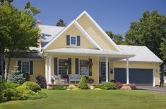 a yellow house with blue shutters and white trim