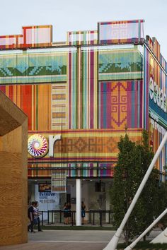 a colorful building with people walking by it