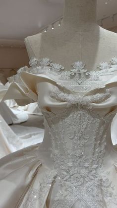 a white wedding dress on display in a store