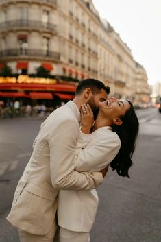 a man and woman are kissing in the street