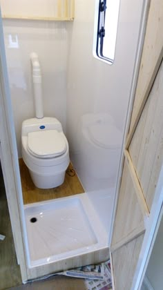 there is a toilet in the corner of this small room with no doors on it