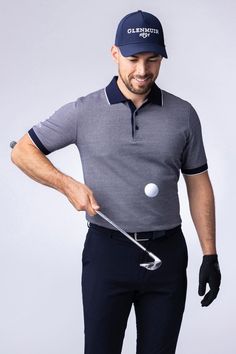 a man holding a golf club and ball