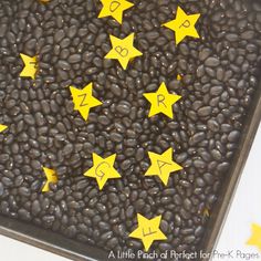 a tray filled with coffee beans and yellow stars