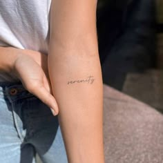 a woman's arm with the word recovery tattooed on her left arm, in cursive font