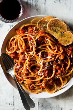 a plate of spaghetti with meat sauce and bread