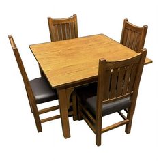 a wooden table with four chairs and a black leather seat on the bottom one side