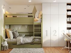 a bedroom with bunk beds and desks in it