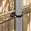 a metal pole is attached to the side of a wooden fence with two black handles