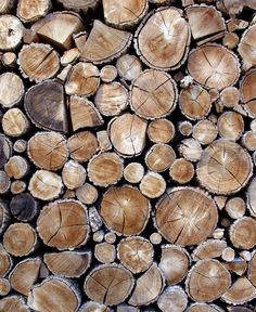 logs are stacked on top of each other and ready to be used as firewood