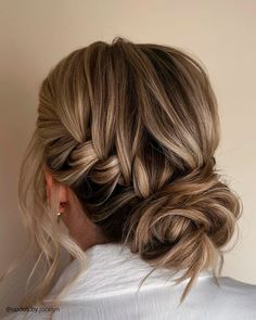 a woman with blonde hair styled into a low bun