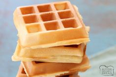 a stack of waffles sitting on top of each other in front of a blue background