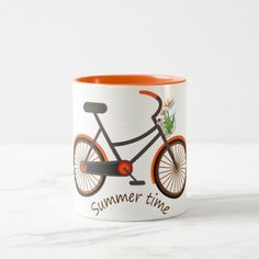 an orange rimmed coffee mug with a bicycle on the front, and words summer time printed on it