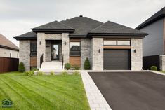 a large house with two garages in the front yard and one car parked on the driveway