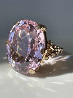 Vintage 40ct Pink Kunzite and 14k Gold Ring. Pretty in Pink! This magnificent Kunzite, weighing a massive 39.9 carats, is perfectly presented in a simple prong setting made of 14k gold with scroll details. Estimated Gemstone weight 39.9 carats Gemstone dimensions 24.5 x 19.25 x 13.3mm 14k gold Weight 18.2 grams Currently Size 9.25 and easily sizeable Note: the color of Kunzite can fade if exposed to strong sunlight for long periods of time. Mafia Princess, Hand Brooch, Kunzite Ring, Pink Kunzite, Princess Luna, Gold Cocktail Ring, Gold Cocktail, Etsy Gold Ring, Spring Jewelry