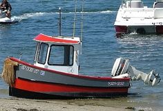 two boats in the water with one being pulled by a boat