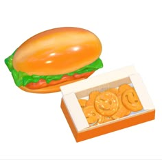 an image of a hamburger and pretzels in a box on a white background