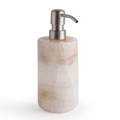 a soap dispenser made out of marble with a stainless steel faucet