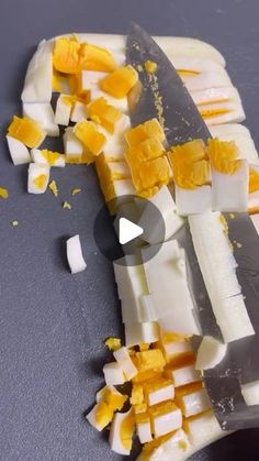 a knife is being used to cut up cheese