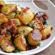 a white plate topped with potatoes covered in parmesan cheese