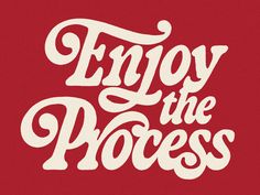 the words enjoy the process written in white on a red background with an ornate font