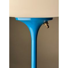 a blue table lamp with a white shade on it