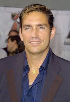 a man in a blue shirt and black jacket