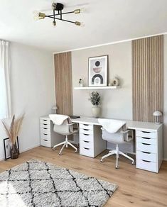 a room with two white desks and a rug on the floor in front of it