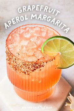 a close up of a drink with a lime on the rim and text overlay that reads grapefruit aperolamariata