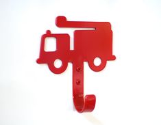 a red piece of metal that is shaped like a truck