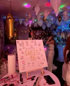 a party with balloons, confetti and sweets on the table for sweet 16