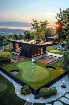 an aerial view of a golf course with a house in the background