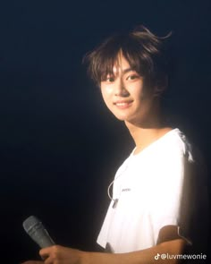 a young man holding a tennis racquet in his right hand