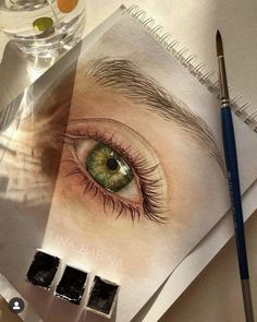 an eye is shown on top of a drawing book