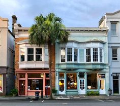 a row of buildings with palm trees on the street in front of them and an article about building plans