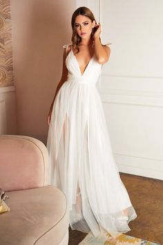 This beautiful dress is a mixture of sexy and sweet as it features a tulle skirt with leg slit on the lining layer and deep V-neck with adjustable tie-strap. Perfect a beach elopement dress. "Fairytale Tulle Maxi Dress" Deep v-neckline Tie shoulder straps Zipper back closure Imported White Backless Maxi Dress, Simple Prom Dress Long, Kate Dress, Cinderella Divine, Low Back Dresses, Simple Prom Dress, Elopement Dress, Plunge Dress, Long Bridesmaid Dress