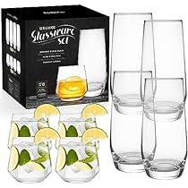 six glasses with lemon slices and limes in them next to a box of whiskey