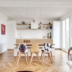 a living room filled with furniture and a flat screen tv on top of a hard wood floor