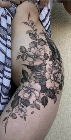 a woman's thigh with flowers on it