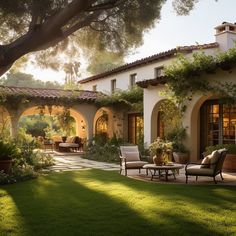 an outdoor patio with chairs and tables in front of a house that is surrounded by greenery