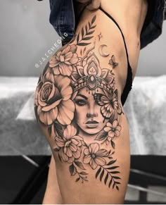 a woman's stomach with flowers and leaves on it